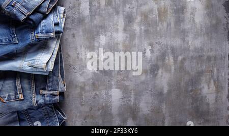 Denim jeans on old abstract background texture of table surface Stock Photo