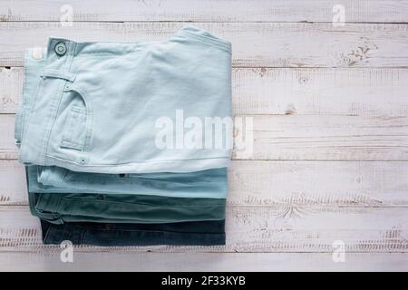Denim jeans on old wooden background texture table surface. Top view Stock Photo