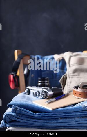 Denim jeans and old retro concept at old wooden chair near black wall background texture. Classic jeans, modern life style and fashion Stock Photo