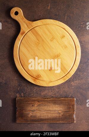 Pizza or bread cutting board for homemade baking on table. Food recipe concept at stone background texture with copy space. Flat lay top view Stock Photo