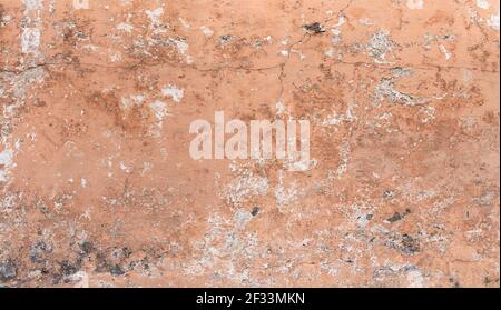 Heavily weathered, apricot-colored wall - old facade background Stock Photo