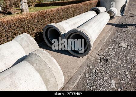 Empty concrete pipes for sewerage on the construction site Stock Photo