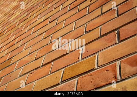 perspective view of a textured brown and orange brick wall. brick background Stock Photo