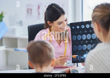 Doctor discussing x-ray results with mom and her son Stock Photo