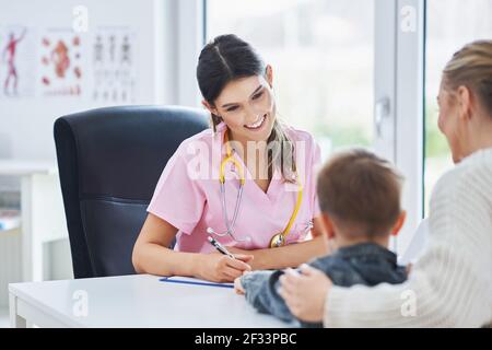 Little boy having medical examination by pediatrician Stock Photo