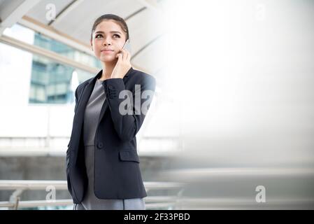 Young Asian businesswoman using smartphone Stock Photo