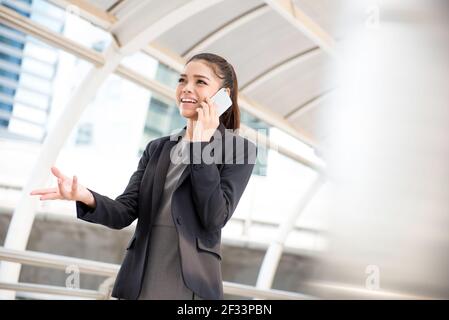 Young Asian businesswoman talking on smartphone Stock Photo