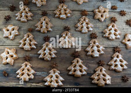 Christmas cookies in the shape of a Christmas tree. New Year's food. Anise star. Festive baked goods. Gingerbread on the table. Pattern. Stock Photo