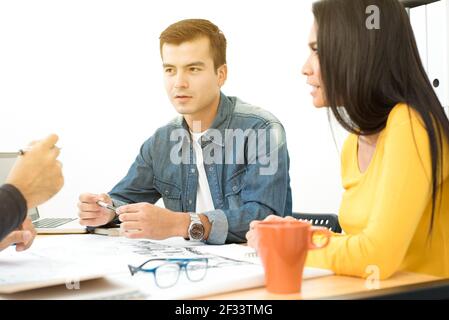 Casual business people (architects or designers) discussing  work in the meeting Stock Photo