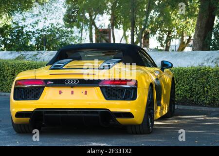 Audi R8 yellow luxury sports car parked outdoors showing rear or back of the vehicle with logo Stock Photo