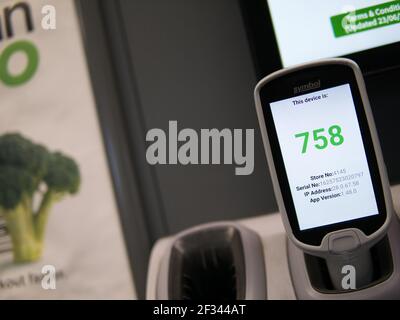 A bar code scanner in a dispenser in an ASDA store in the UK. The device is ready for use by a customer to self-scan the products they want to buy Stock Photo