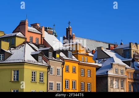 Historic tenement houses with snow covered roofs in winter, Old Town of Warsaw city in Poland. Stock Photo