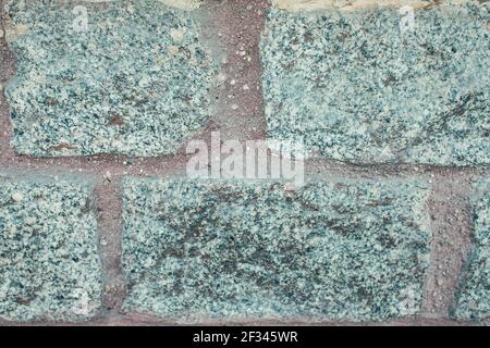 stone wall made of grey, unpolished granite Stock Photo