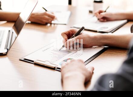 group of the employees analyzing financial charts Stock Photo