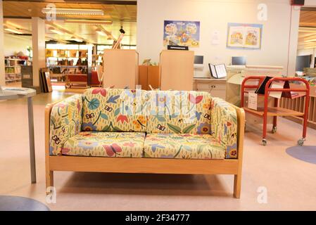 a small floral sofa in a school library Stock Photo