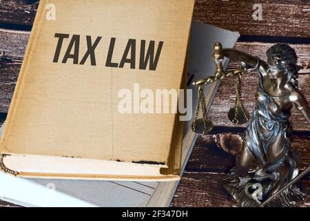 Justitia, code of law and tax law Stock Photo