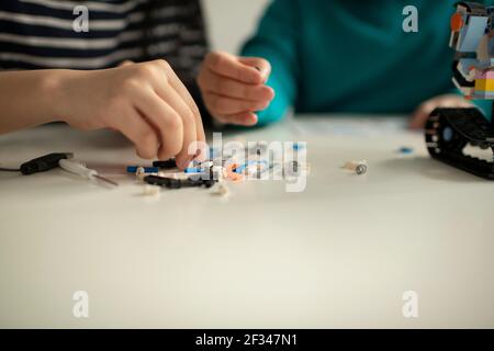 Elementary School Students Assembling Programming Robot Stock Photo