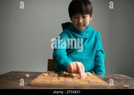 Elementary School Student as a Shogi (Japanese Chess) Player Stock Photo