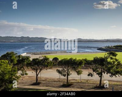 ANZAC Peace Park on Princess Royal Harbour with wind turbines on the horizon across the water,  Albany, Western Australia Stock Photo