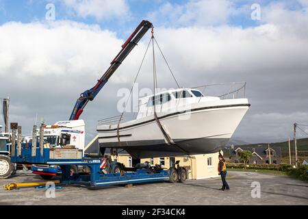 Boat being hoisted by Mobile Crane in Boatyard, County Kerry, Ireland Stock Photo