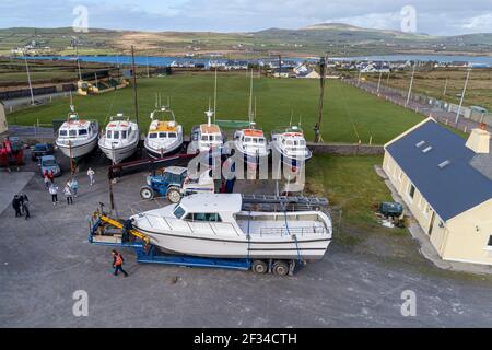 Boat being hoisted by Mobile Crane in Boatyard, County Kerry, Ireland Stock Photo