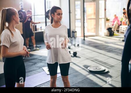 Young ladies staying in shape by working out at gym Stock Photo