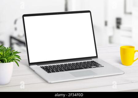 Laptop mockup close-up on white desk. Work from home concept Stock Photo