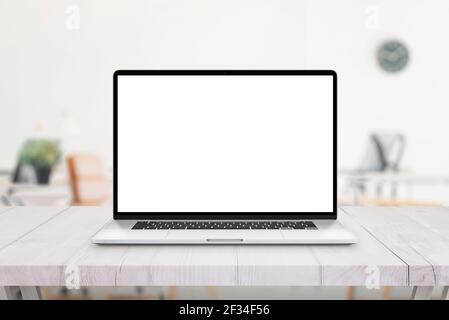 Laptop on office desk. Isolated screen for mockup, app or web site presentation. Clean white wooden desk. Office in bacgkround Stock Photo