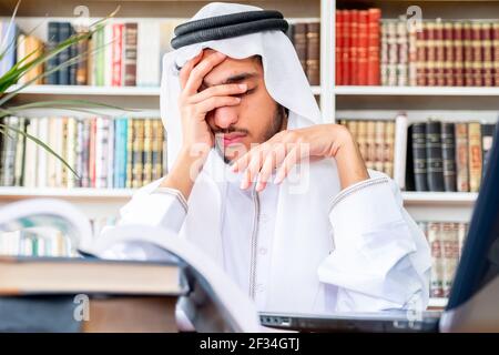 Arabic Muslim man feeling upset while studying online Stock Photo