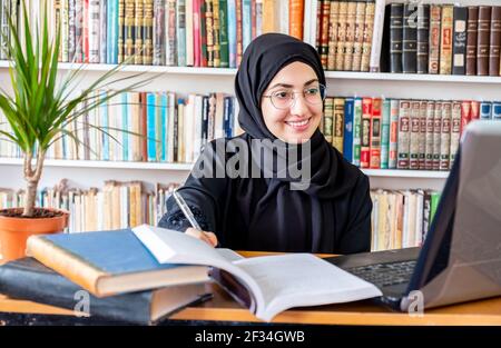 Arabic Muslim woman studying online Stock Photo