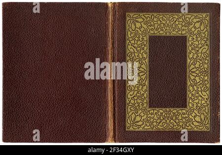 Old open book in textured brown canvas cover with significant golden celtic knots frame - circa 1920 Stock Photo