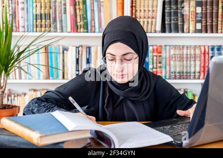 Arabic Muslim woman studying online Stock Photo