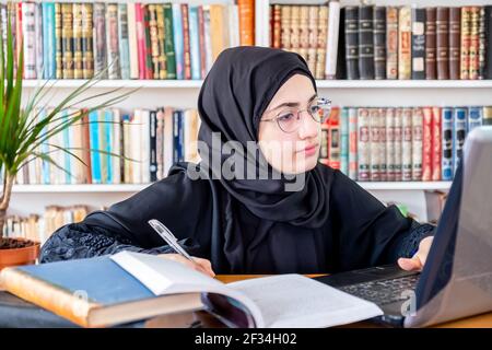 Arabic Muslim woman studying online Stock Photo