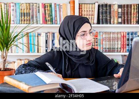 Arabic Muslim woman studying online Stock Photo