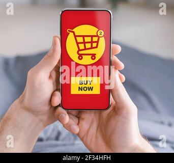Closeup of man hands holding smartphone with shopping application Stock Photo