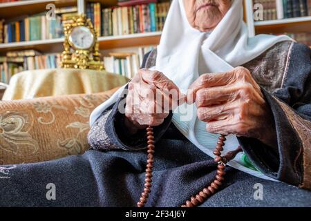 Arabic Muslim man praying for god using rosary Stock Photo
