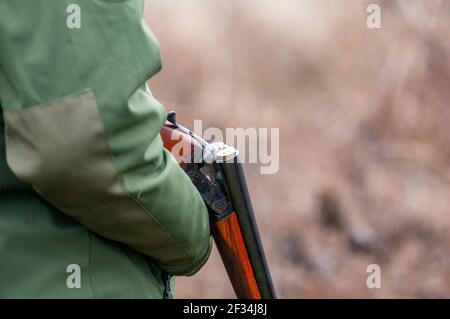 Close up shot of an unloaded gun held by a hunter. Copy space Stock Photo