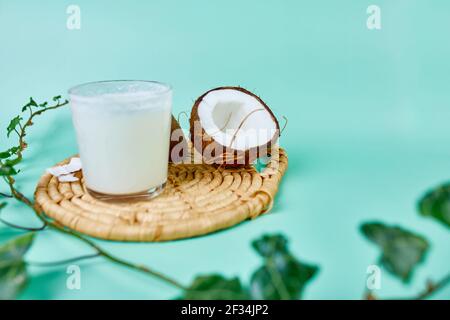 Fresh healthy coconut milk in a glass on blue background, Alternative type of vegan milks, Organic Healthy drink concept. Stock Photo