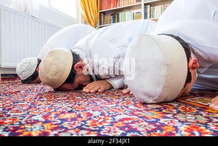 Happy Arabic family praying together Stock Photo