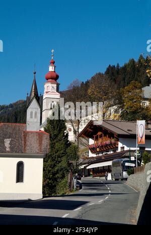 Maria Luggau, Austria - October 13, 2007: Unidentified people, hotel and pilgrimage church in Carinthia Stock Photo