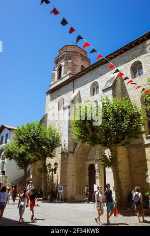 Saint Jean de Luz, French Basque Country, France - July 19th, 2019 : People walk past the Church of St. John the Baptist in the historic center of Sai Stock Photo