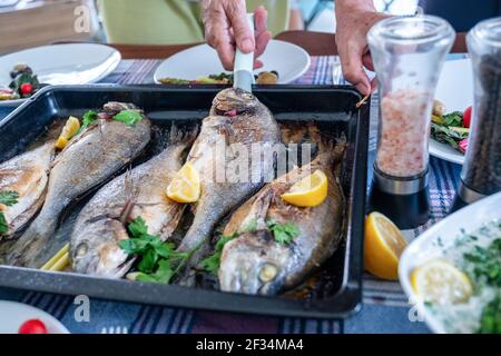 Family gathering to eat fish together Stock Photo