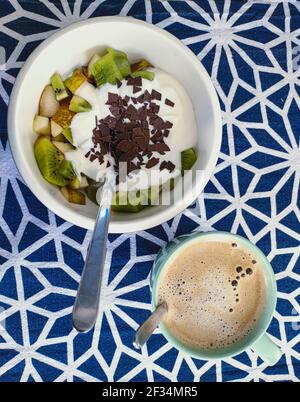 fruits with yoghurt in bowl with coffe for breakfast Stock Photo