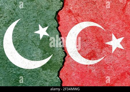 An overlay of the Pakistani and Turkish flags on a weathered cracked wall background. Pakistan versus Turkey concept Stock Photo