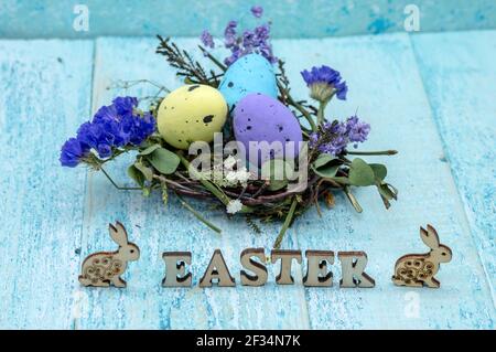 Happy Easter. Easter eggs. Willow twigs. Holy Easter. Blue background. The word Easter. Easter bunny and chicken. Stock Photo