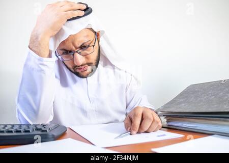 Arabic Muslim feeling stressed at work Stock Photo