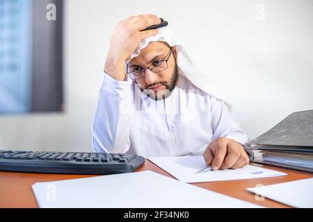 Arabic Muslim feeling stressed at work Stock Photo