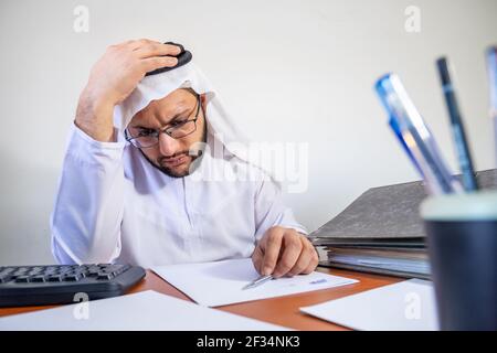 Arabic Muslim feeling stressed at work Stock Photo