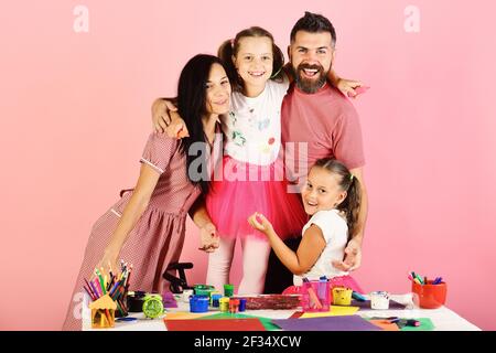 Parents and children hold colorful markers and pose Stock Photo