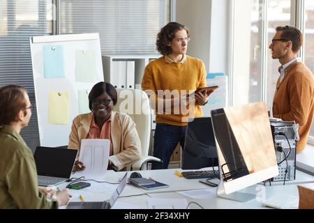 Portrait of diverse IT development team collaborating on business project while working in software production studio Stock Photo